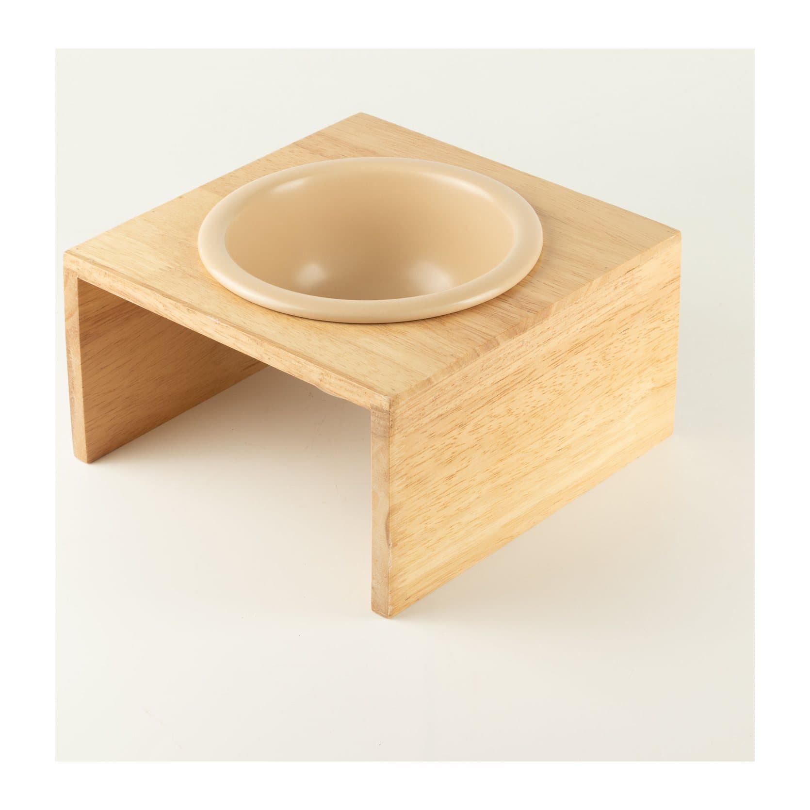Large cream ceramic pet bowl sitting in a light wooden stand