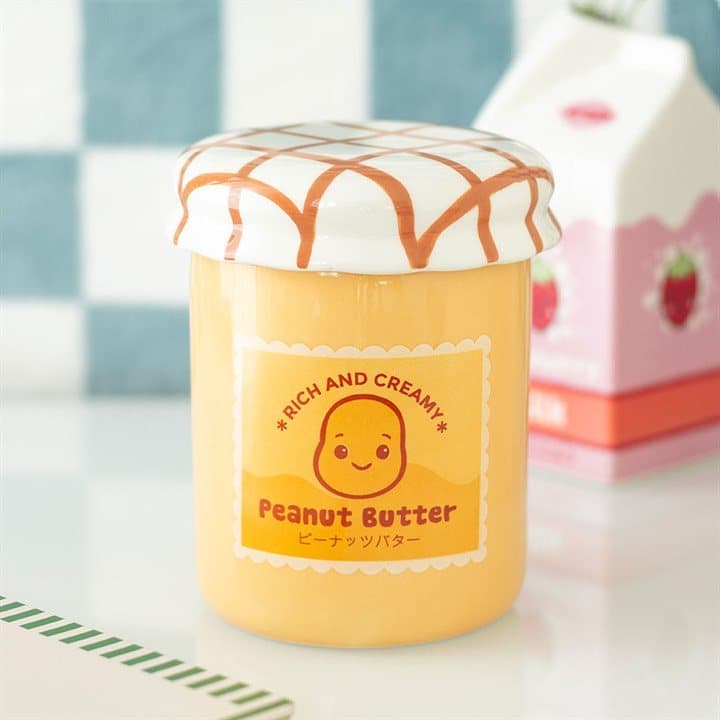 Ceramic peanut butter jar oil burner with smiling face and label design
