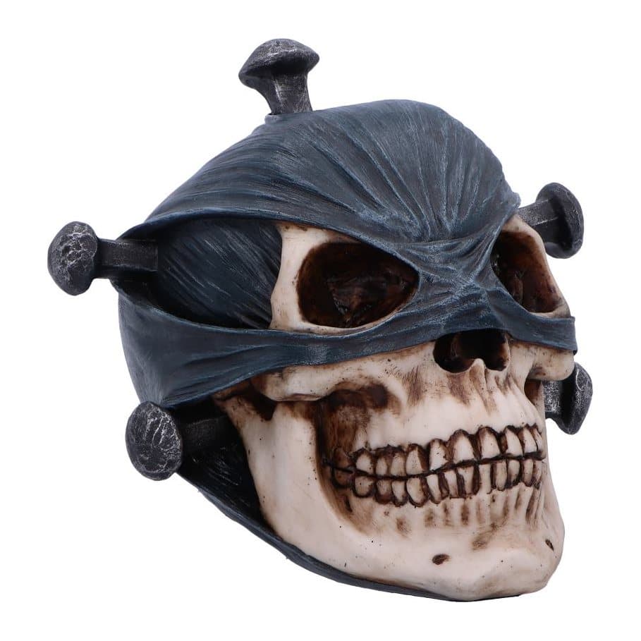 Gothic skull figurine with a mask over the upper half and nails in the cranium
