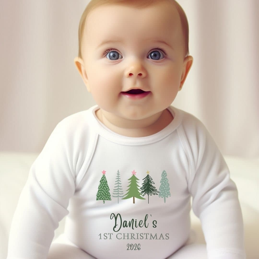 Personalised baby grow with a row of fir trees and green lettering