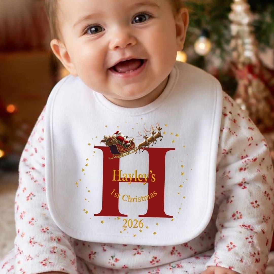 Personalised baby grow with a Santa sleigh and reindeer design and a name.