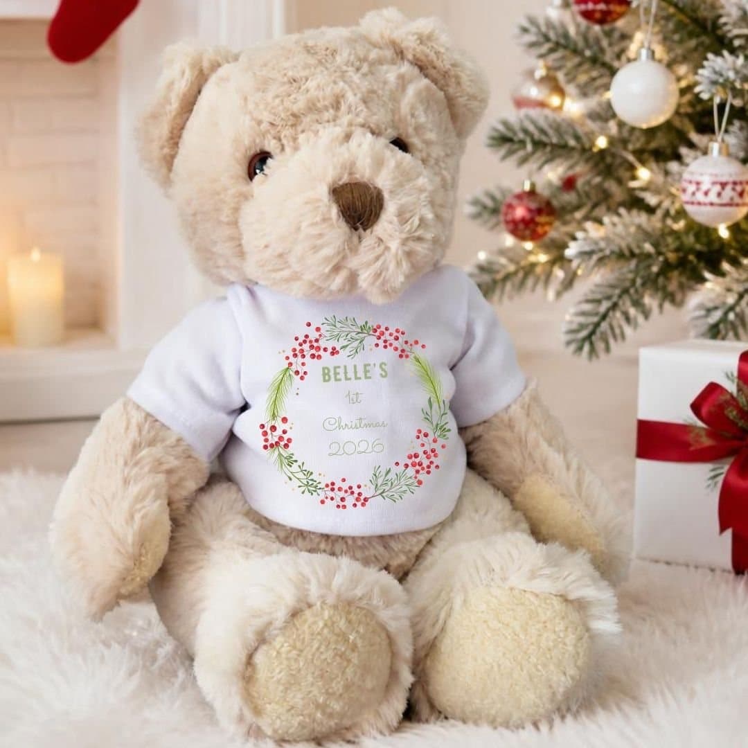 Teddy bear in a T-shirt with a festive berry wreath design and a name printed on it