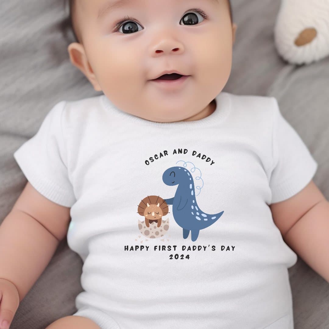 Personalised dinosaur baby clothing with a Happy First Daddy's Day 2026 design