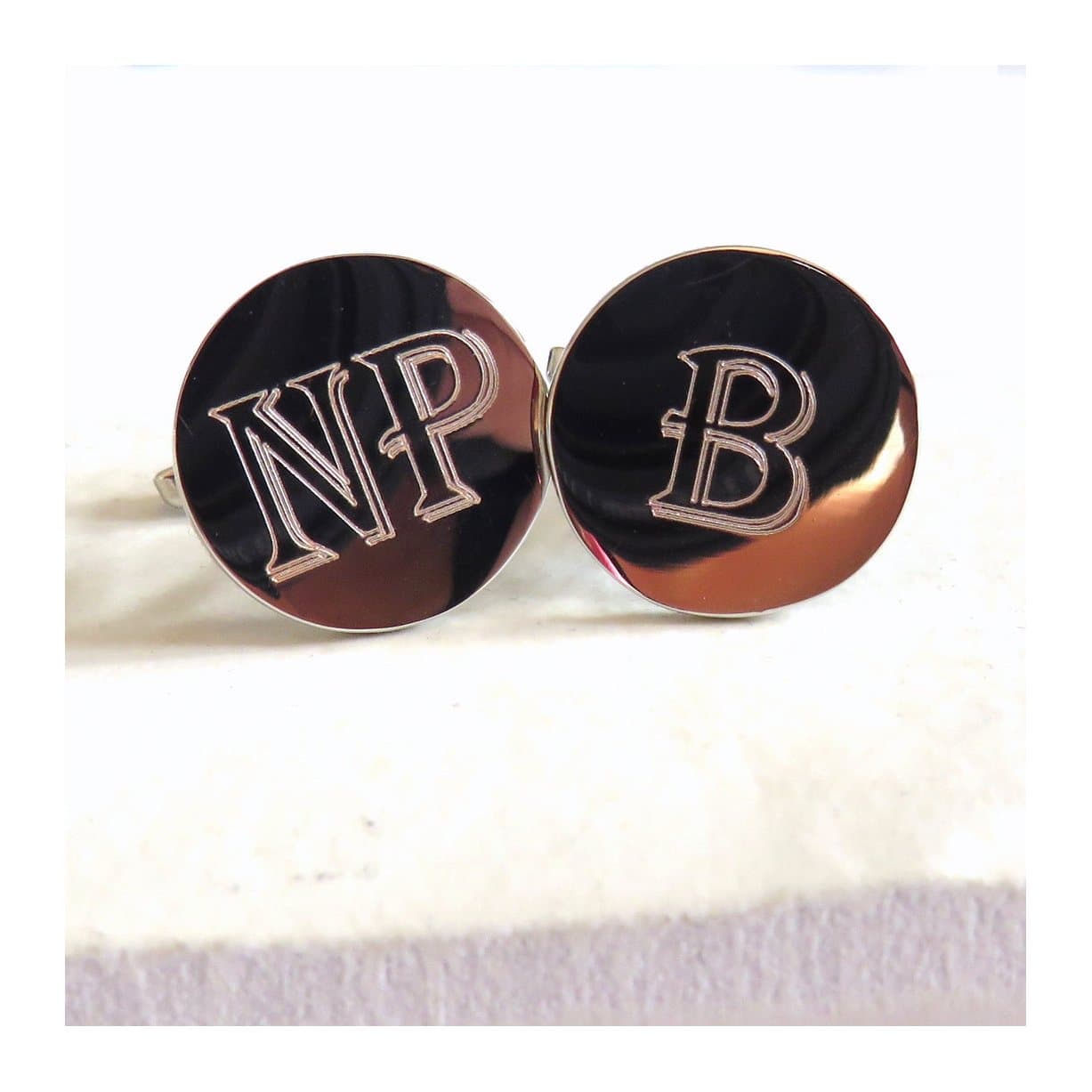 Round personalised cufflinks with an engraved initial