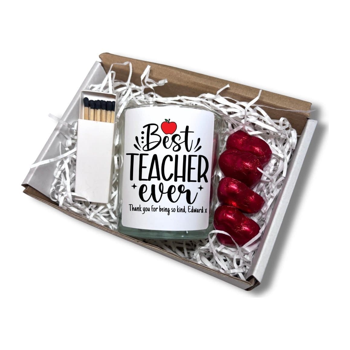 Best Teacher Ever candle with a red apple, beside red foiled chocolate hearts