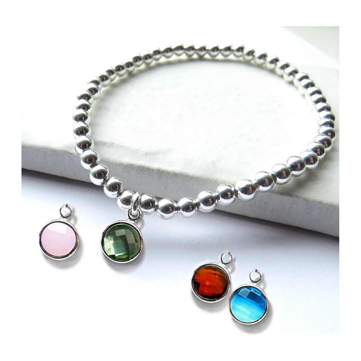 Silver beaded stretch bracelet with a faceted coloured glass birthstone charm