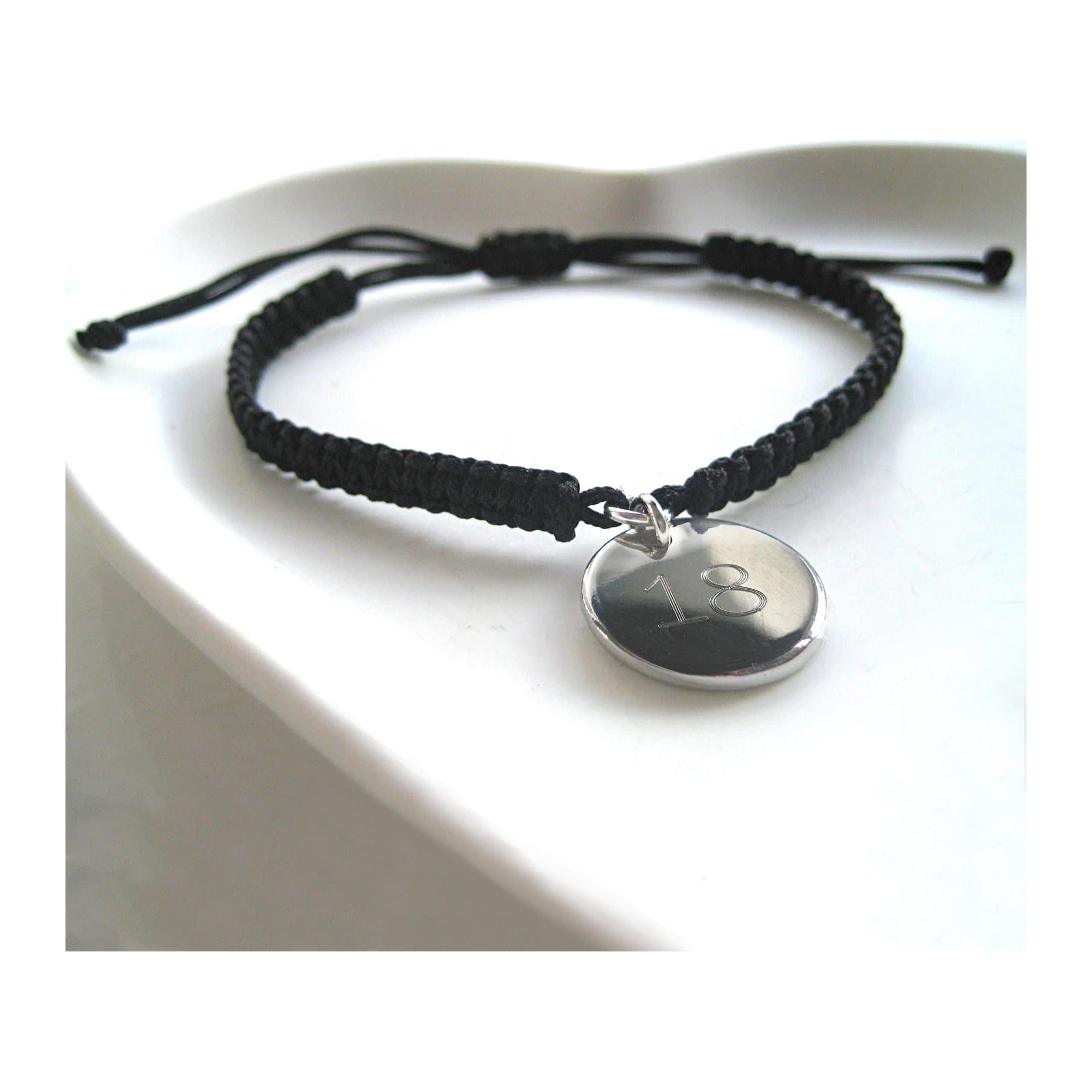 Braided nylon friendship bracelet with a round engraved stainless steel disc