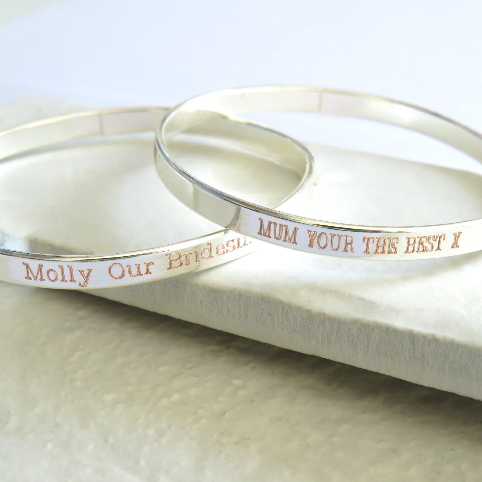 A thin personalised engraved bangle with a name or message.