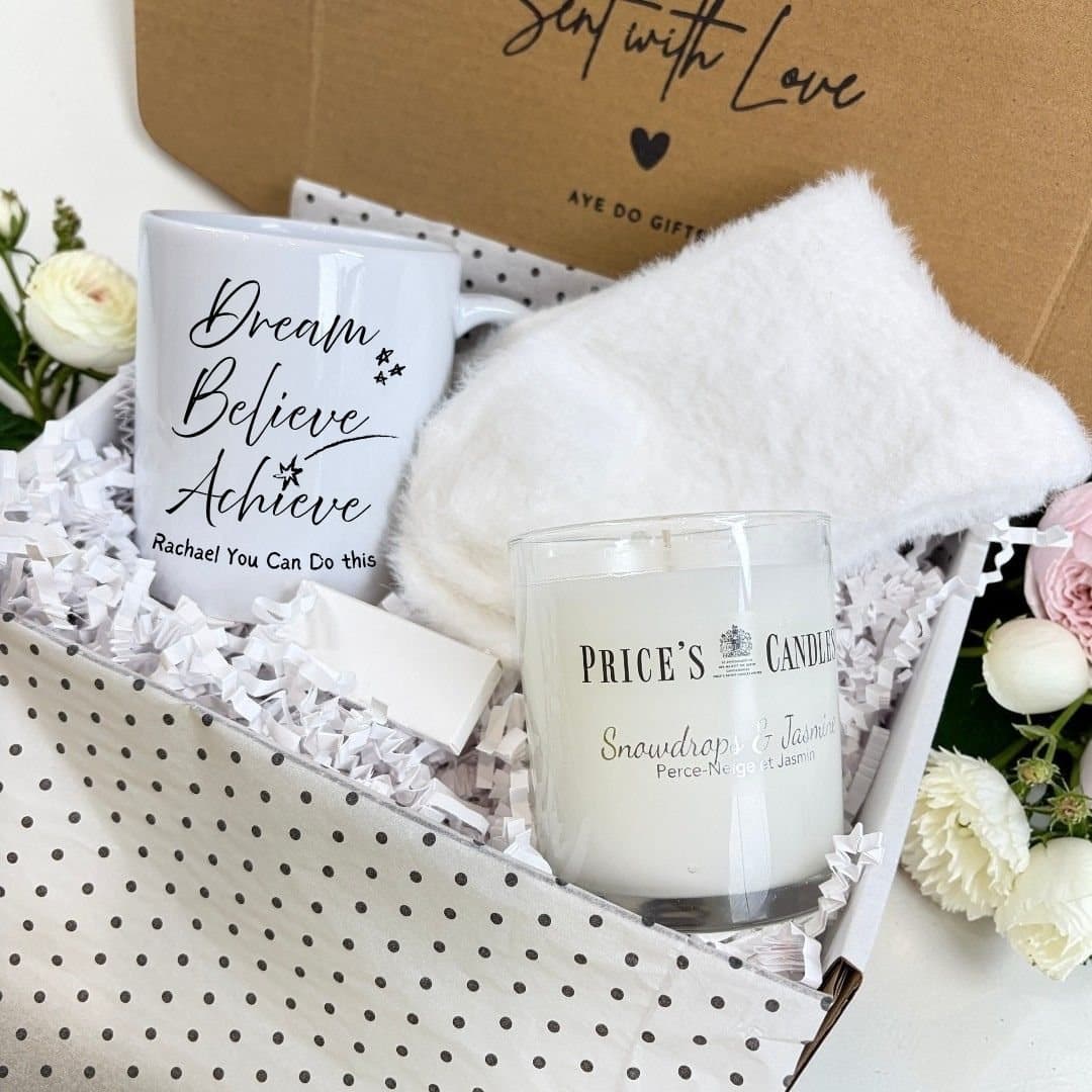 Personalised mug, fluffy socks, scented candle and box of matches in a gift hamper