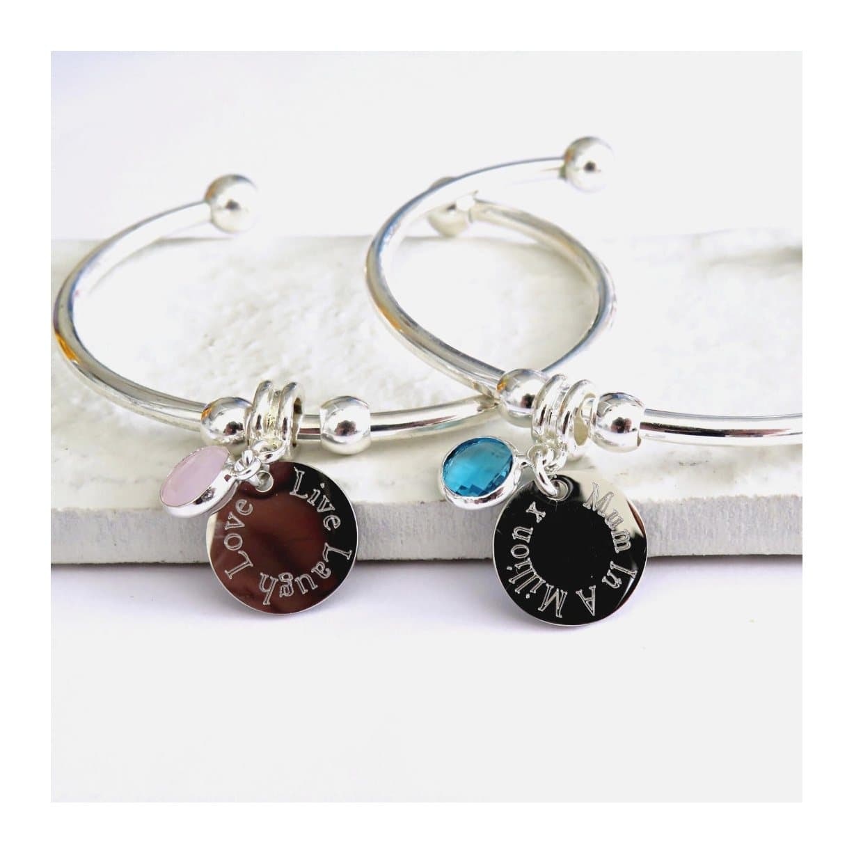 Personalised birthstone bangle with a silver round charm and birthstone charm