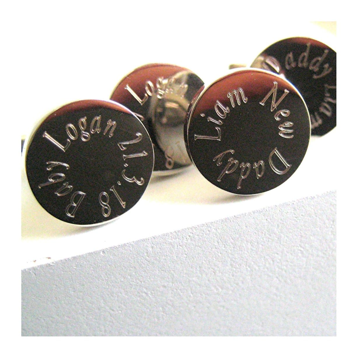 Silver coloured round personalised cufflinks with a name engraved around the edge.