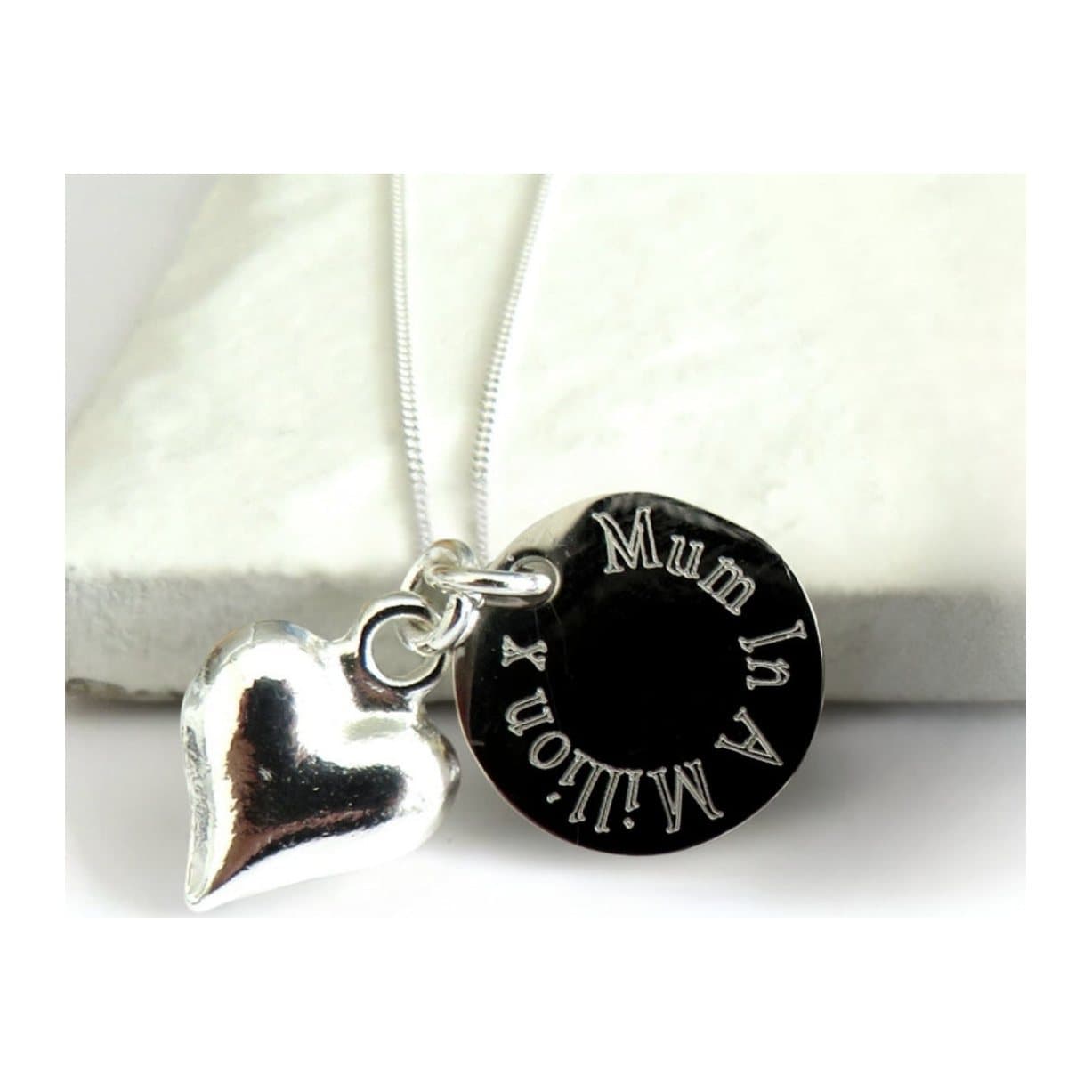 Silver heart charm necklace with a round engraved charm