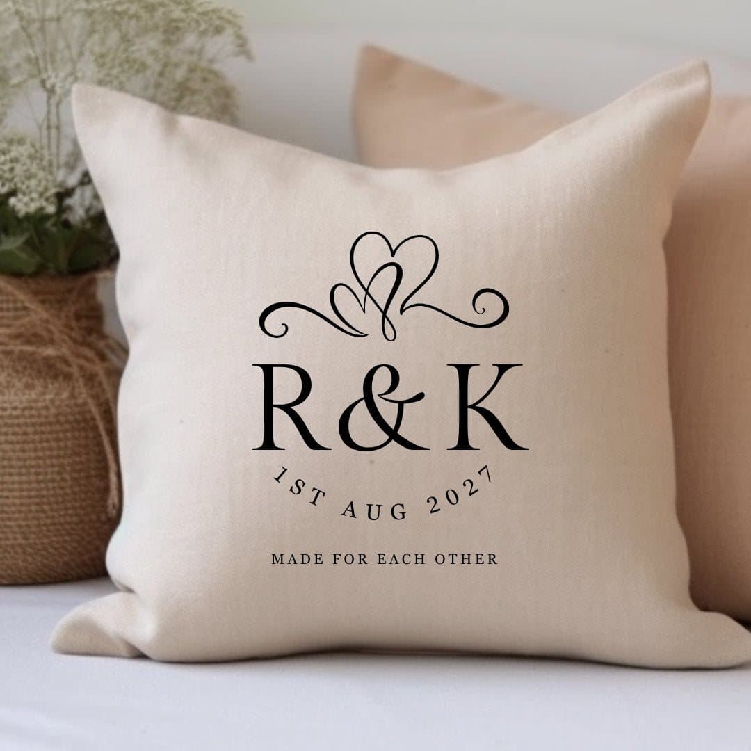Cream linen-look cushion with two intertwined hearts design