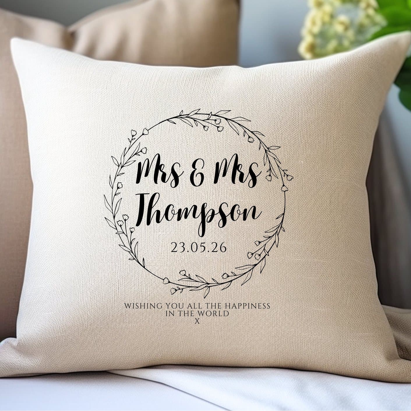 Cream linen-look cushion with black script and a wild flower circle