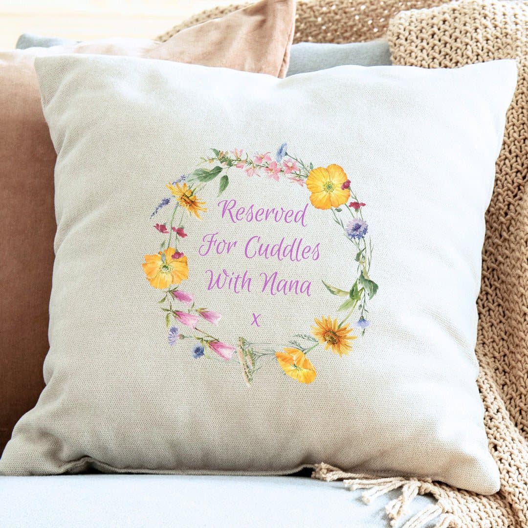 Cream personalised cushion with yellow, pink and purple flowers and pink lettering