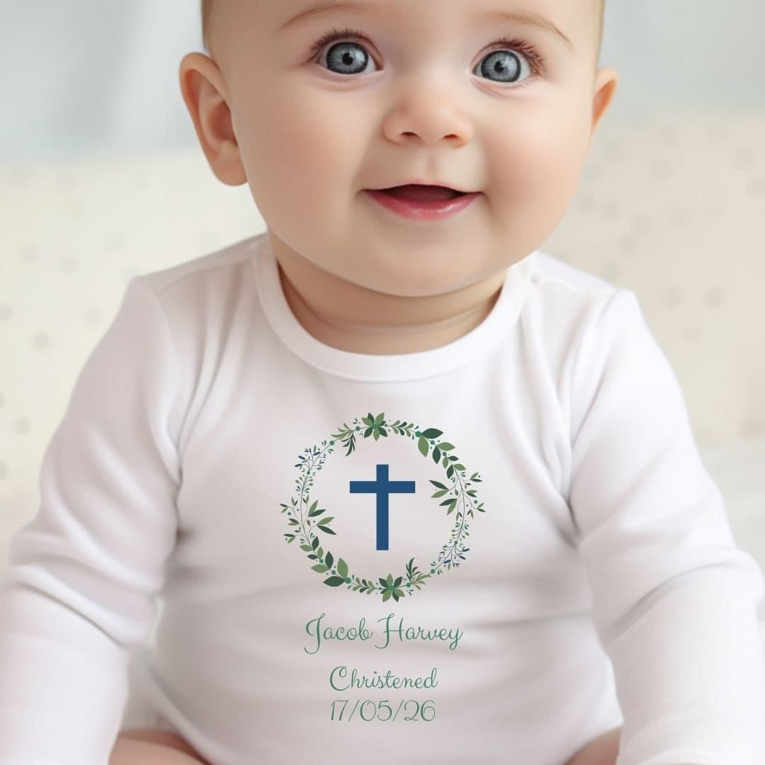 Personalised green christening baby outfit with foliage artwork and a name.