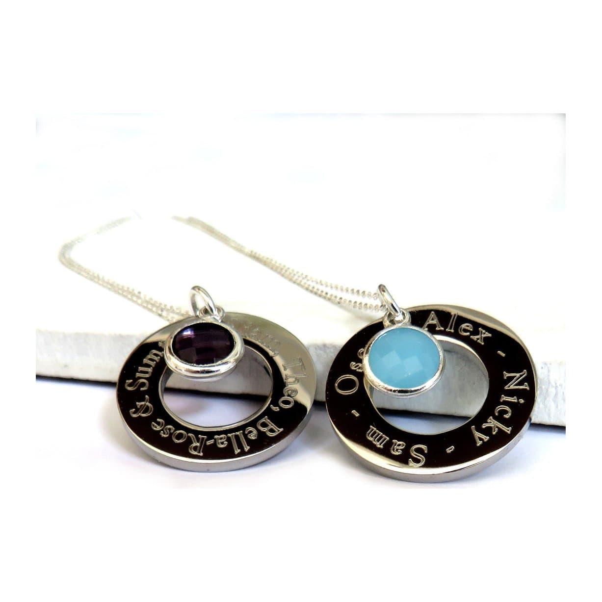 Personalised infinity birthstone necklace with a round disc and faceted birthstone.