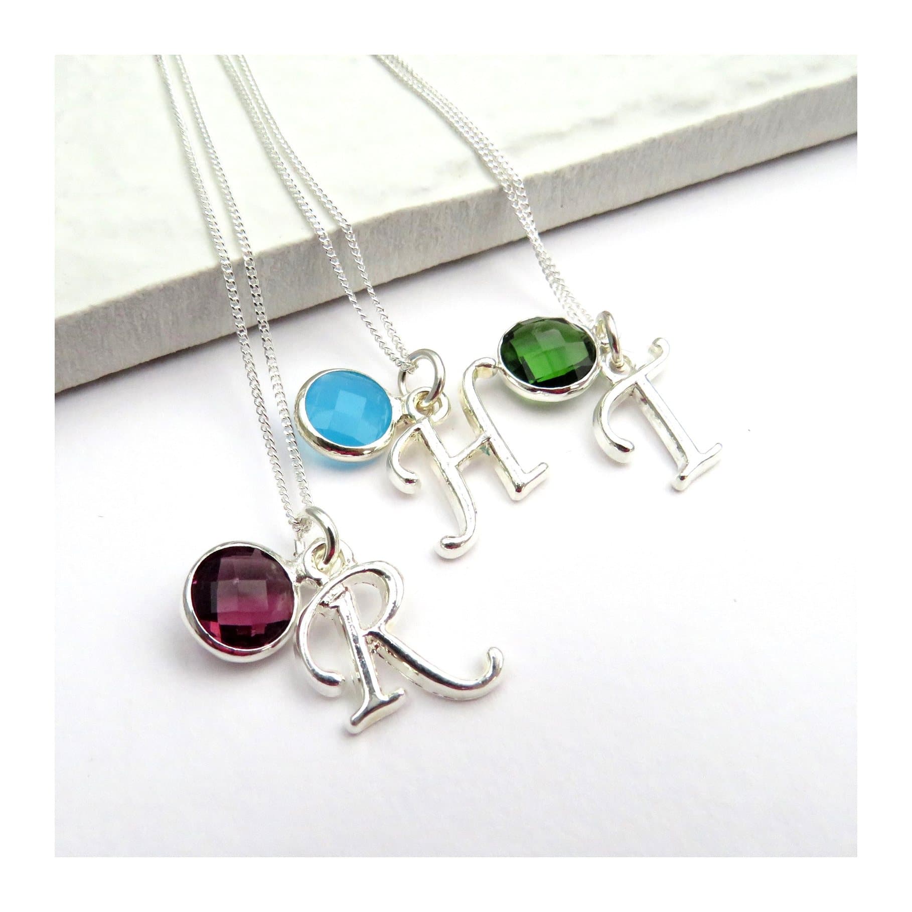 Sterling silver necklace with a silver initial charm and a coloured birthstone charm