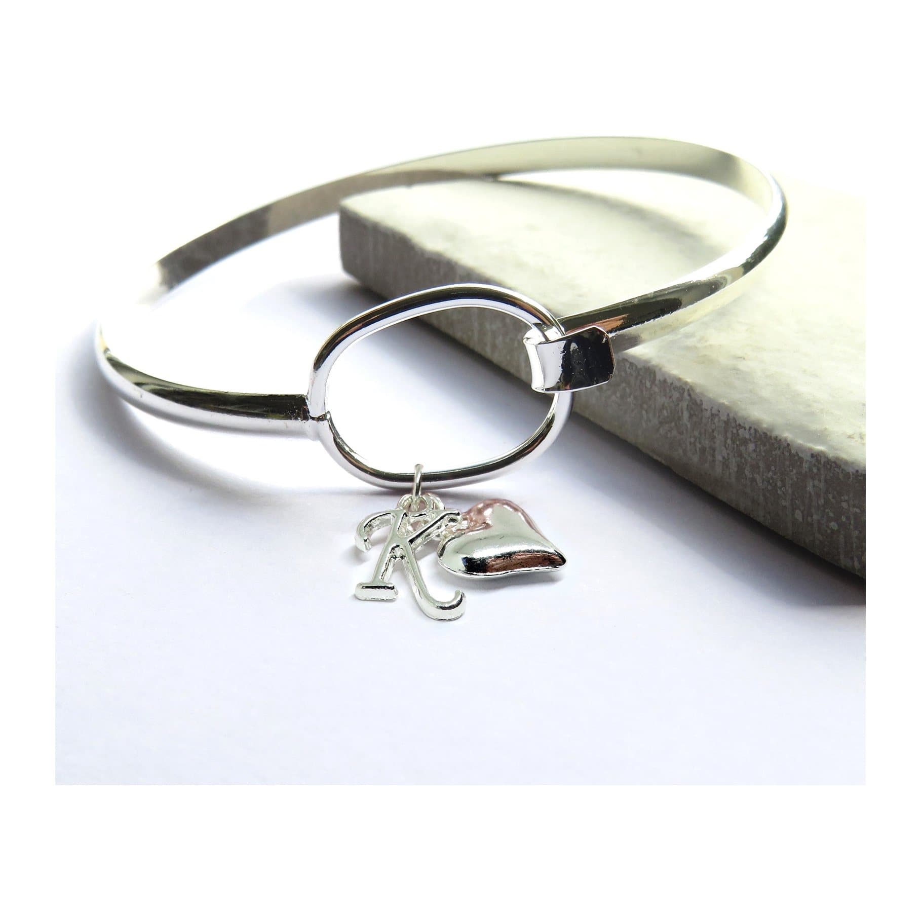 Silver plated personalised loop bangle with a heart charm and initial