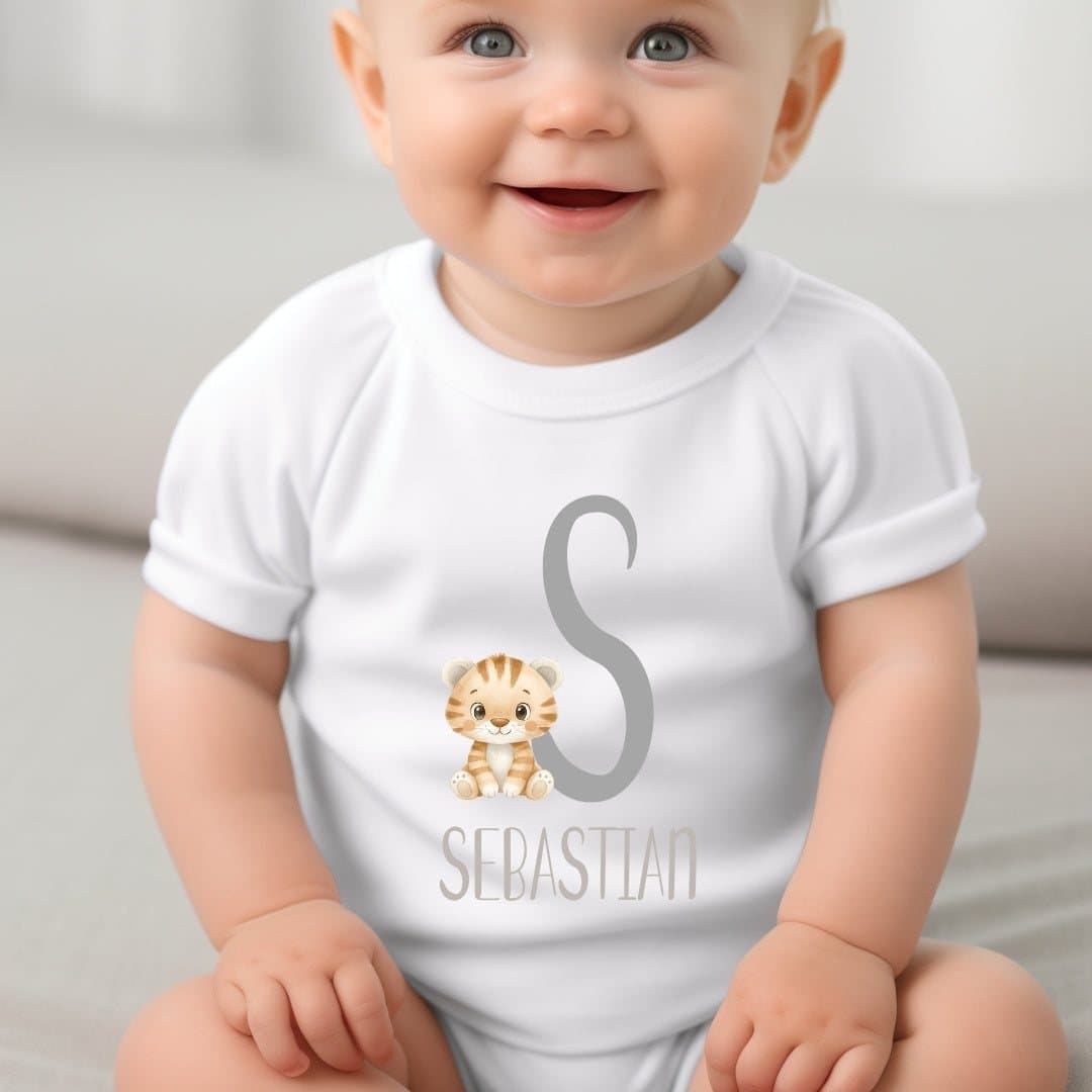 Personalised tiger baby outfit with name and initial beside the tiger design