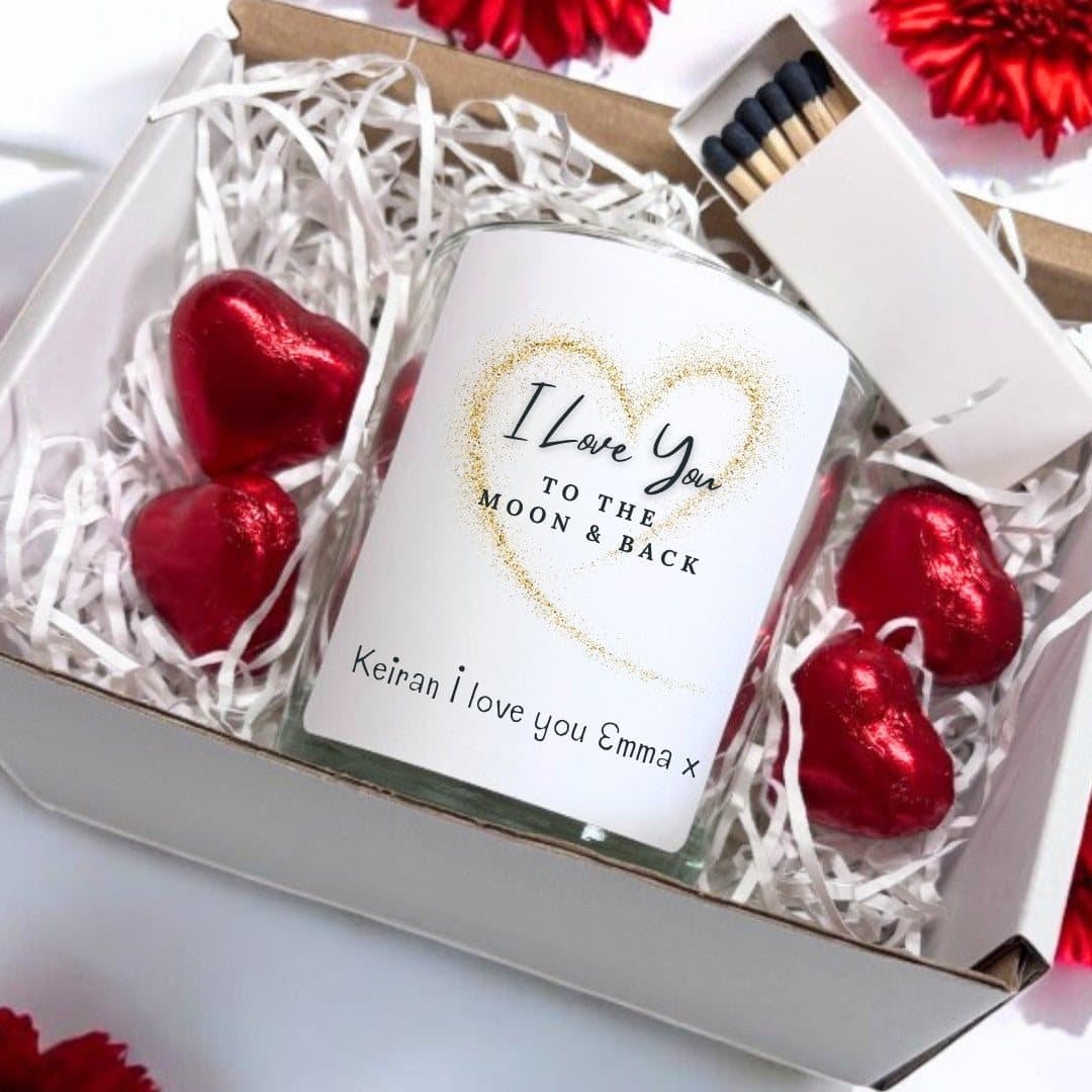 Candle in a glass jar reading Love You to the Moon and Back, with chocolate hearts