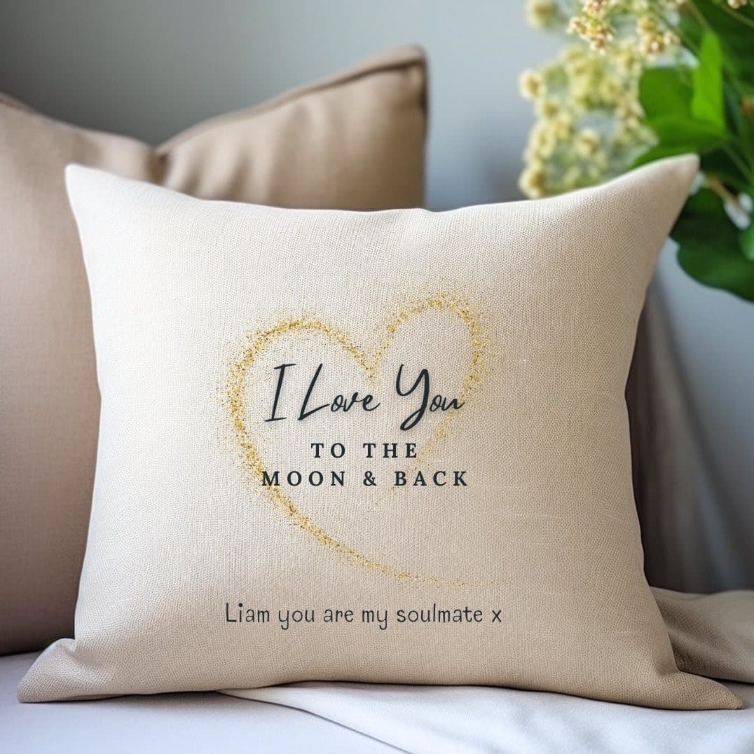 Cream cushion with a golden heart and the words Love You to the Moon & Back