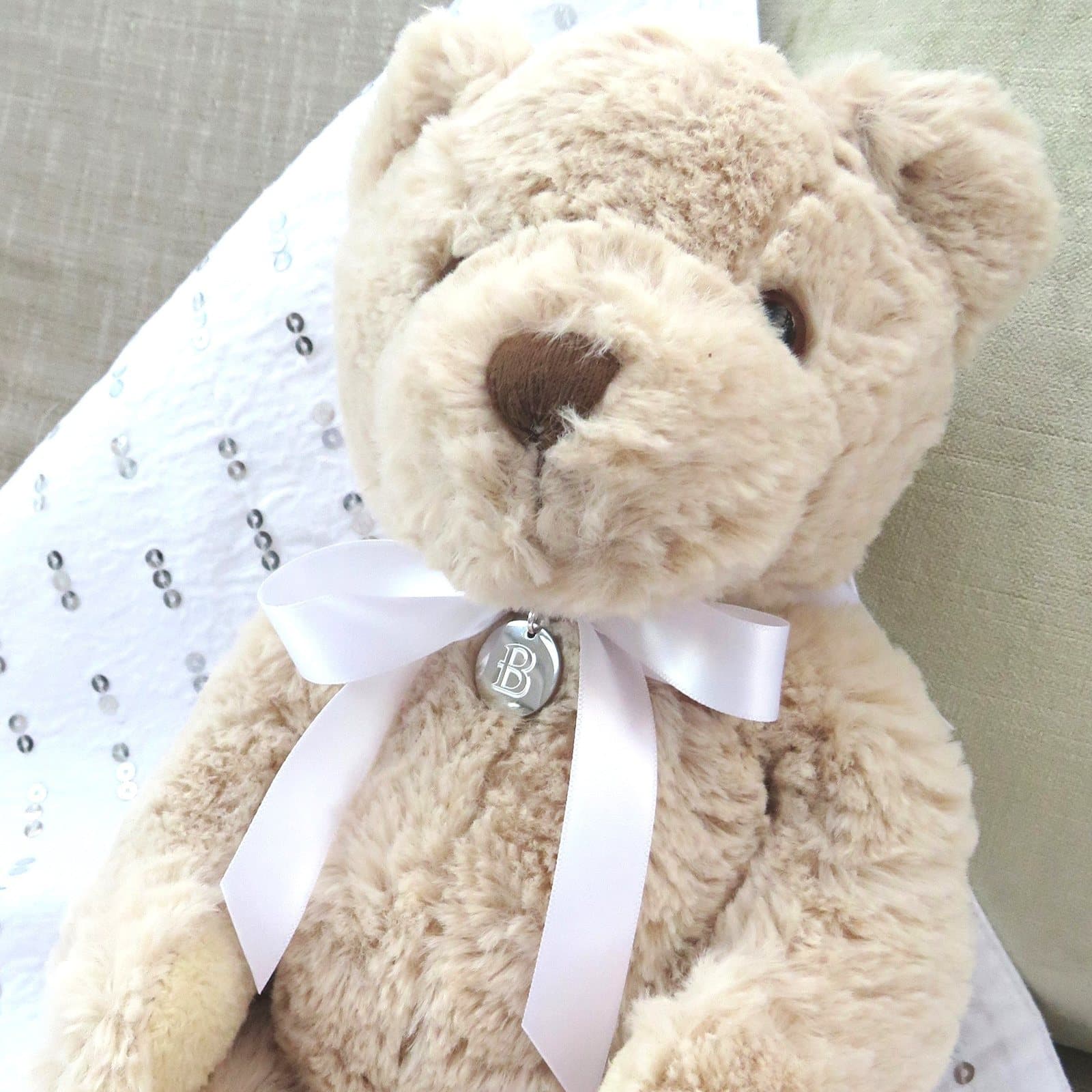 Personalised luxury teddy bear with a letter disc on a white satin ribbon