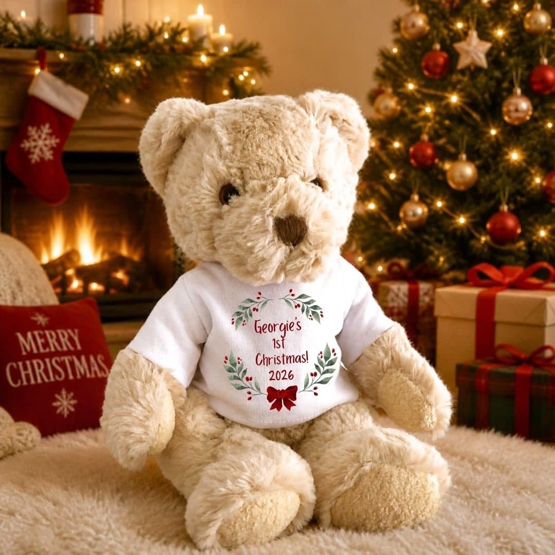 Personalised teddy bear with holly, berries and a red bow on a 1st Christmas T-shirt