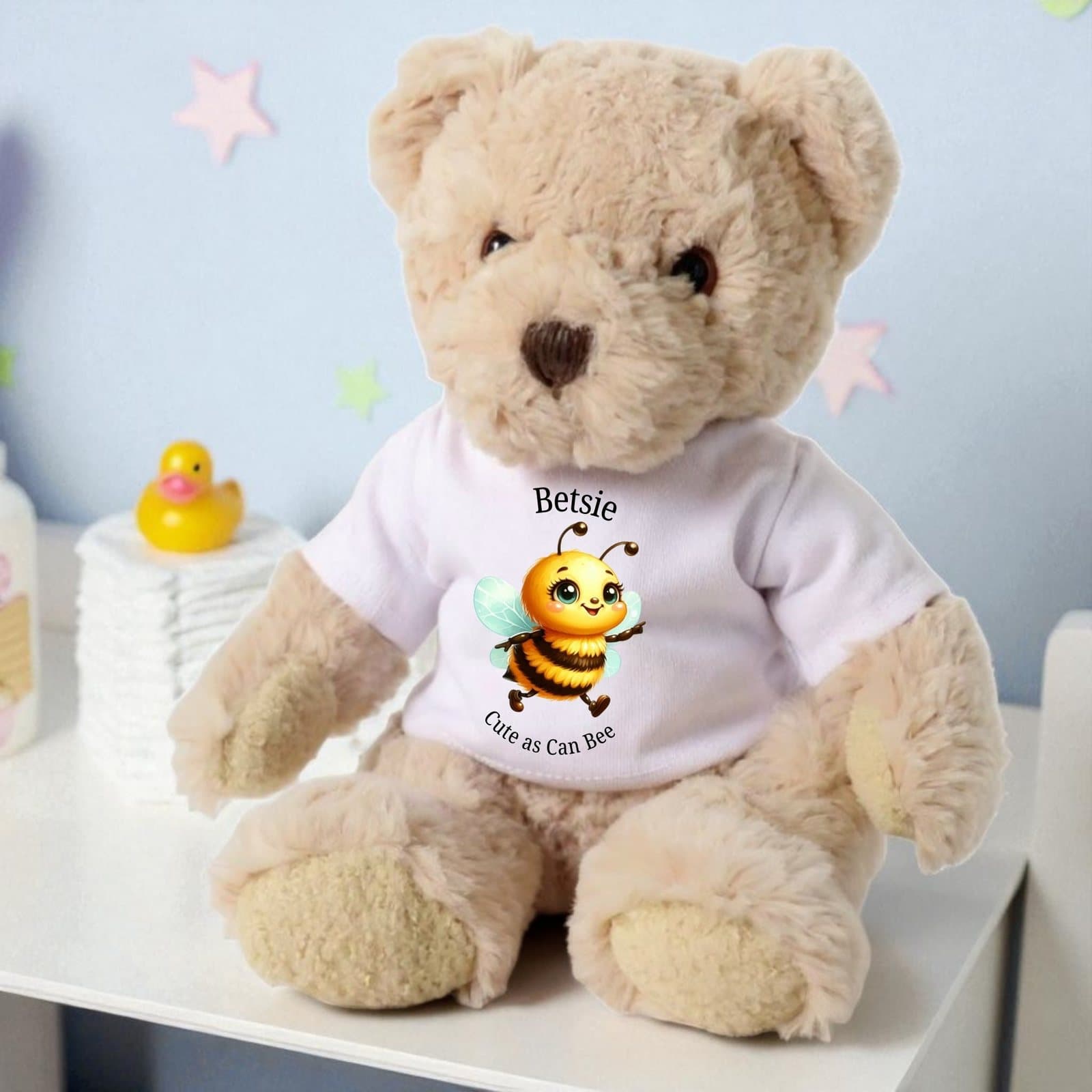 Teddy bear in a printed T-shirt with a bee and the words Cute as Can Bee