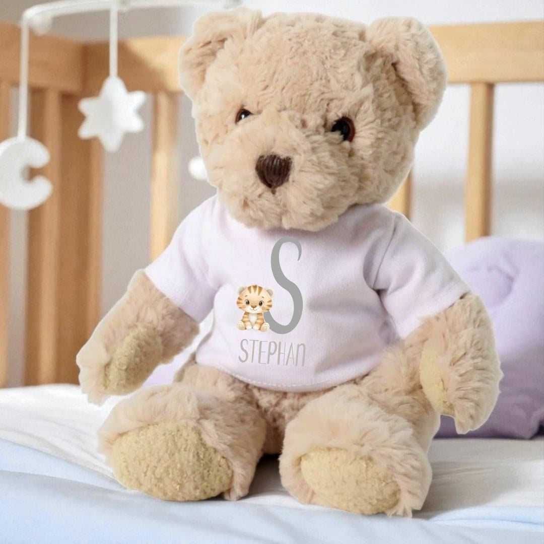 Teddy bear in a printed T-shirt with a tiger design and a name