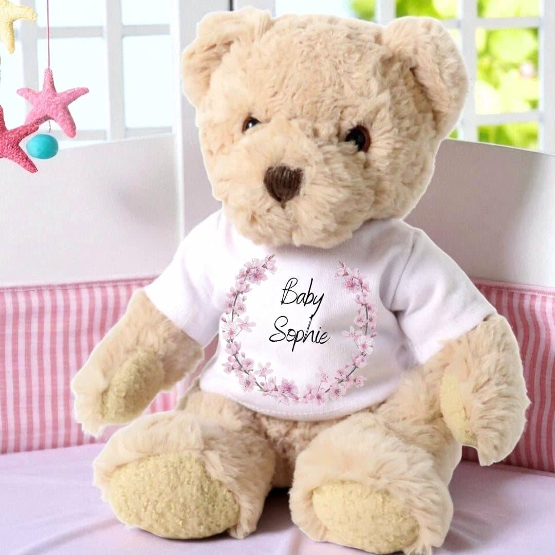 Personalised teddy bear in a pink blossom T-shirt with a name printed in the centre.