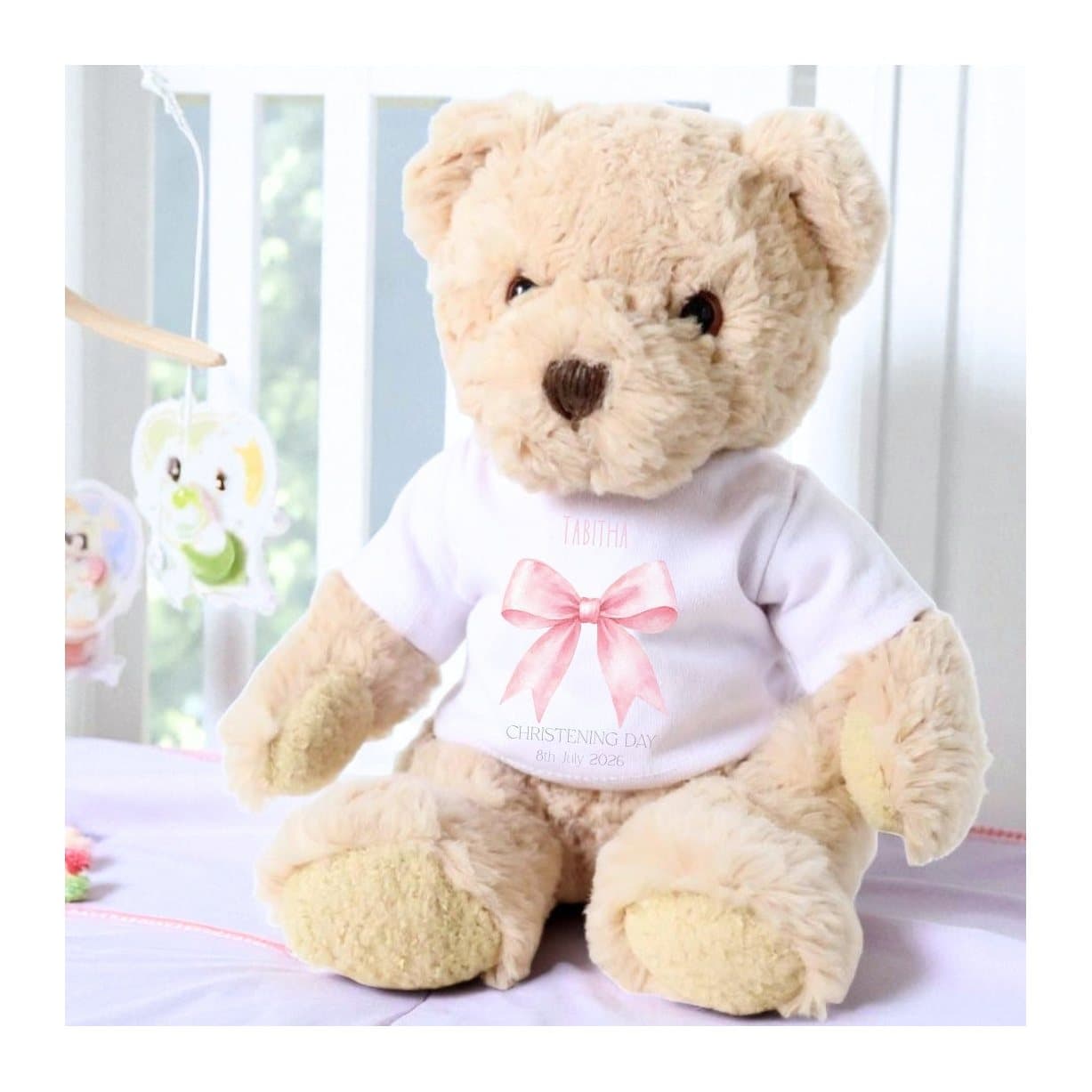 Personalised teddy bear in a T-shirt with a pink bow design