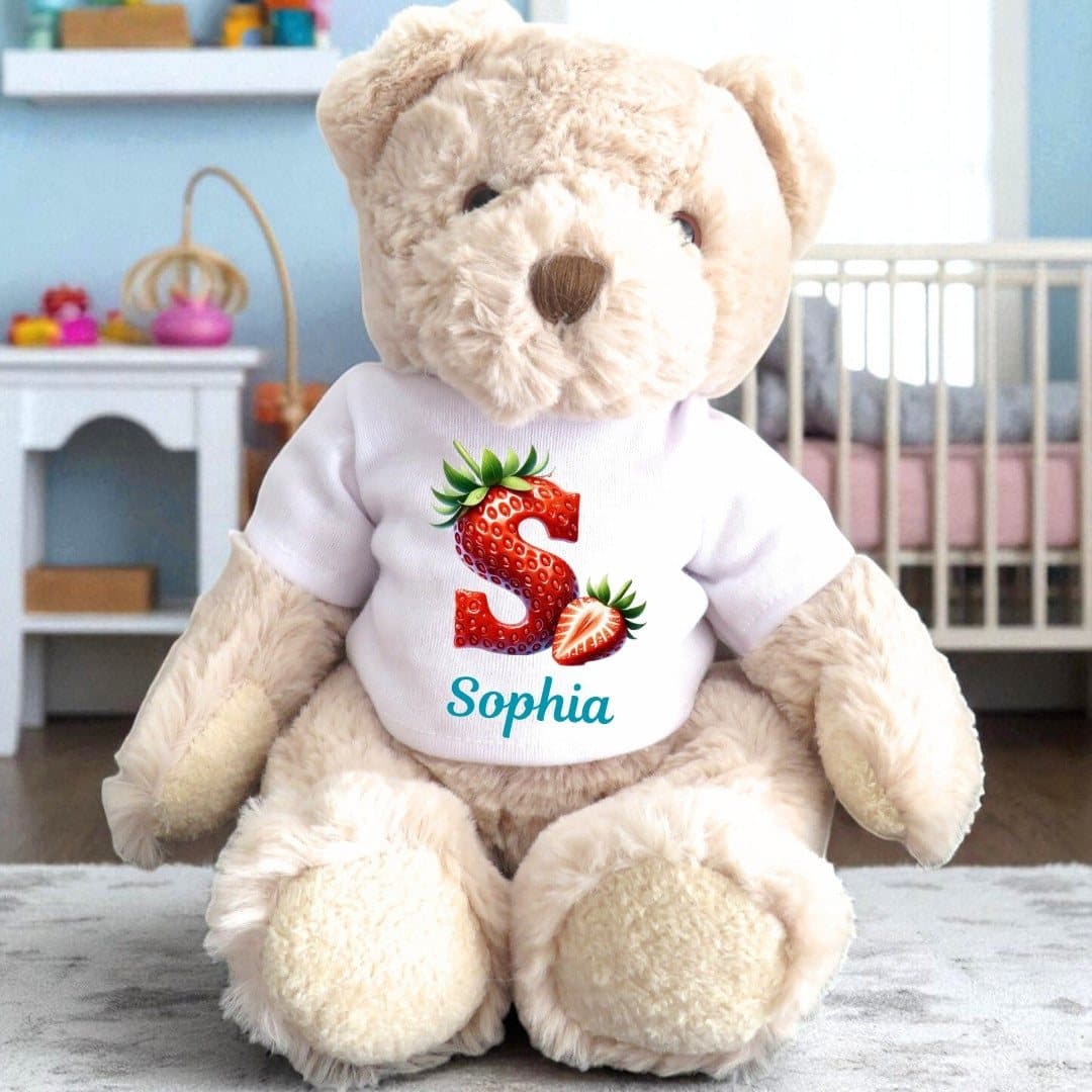 Personalised teddy bear in a printed T-shirt with a strawberry initial and name design