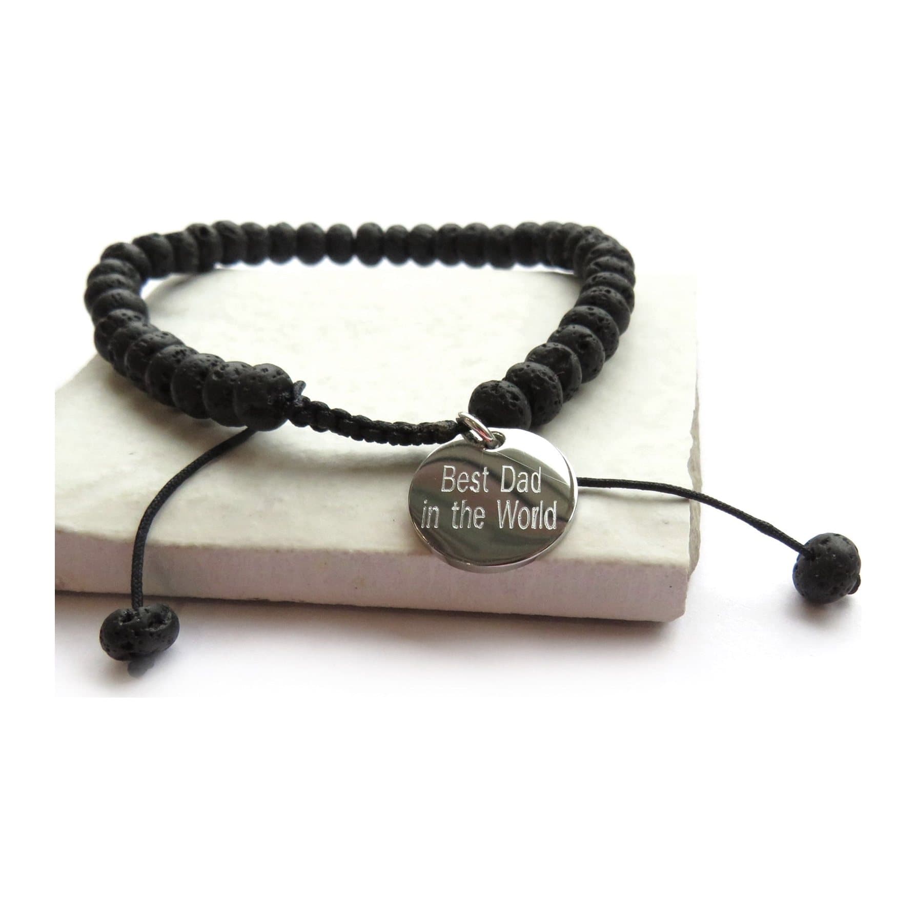 Black lava bead bracelet with a round stainless steel charm for personalising