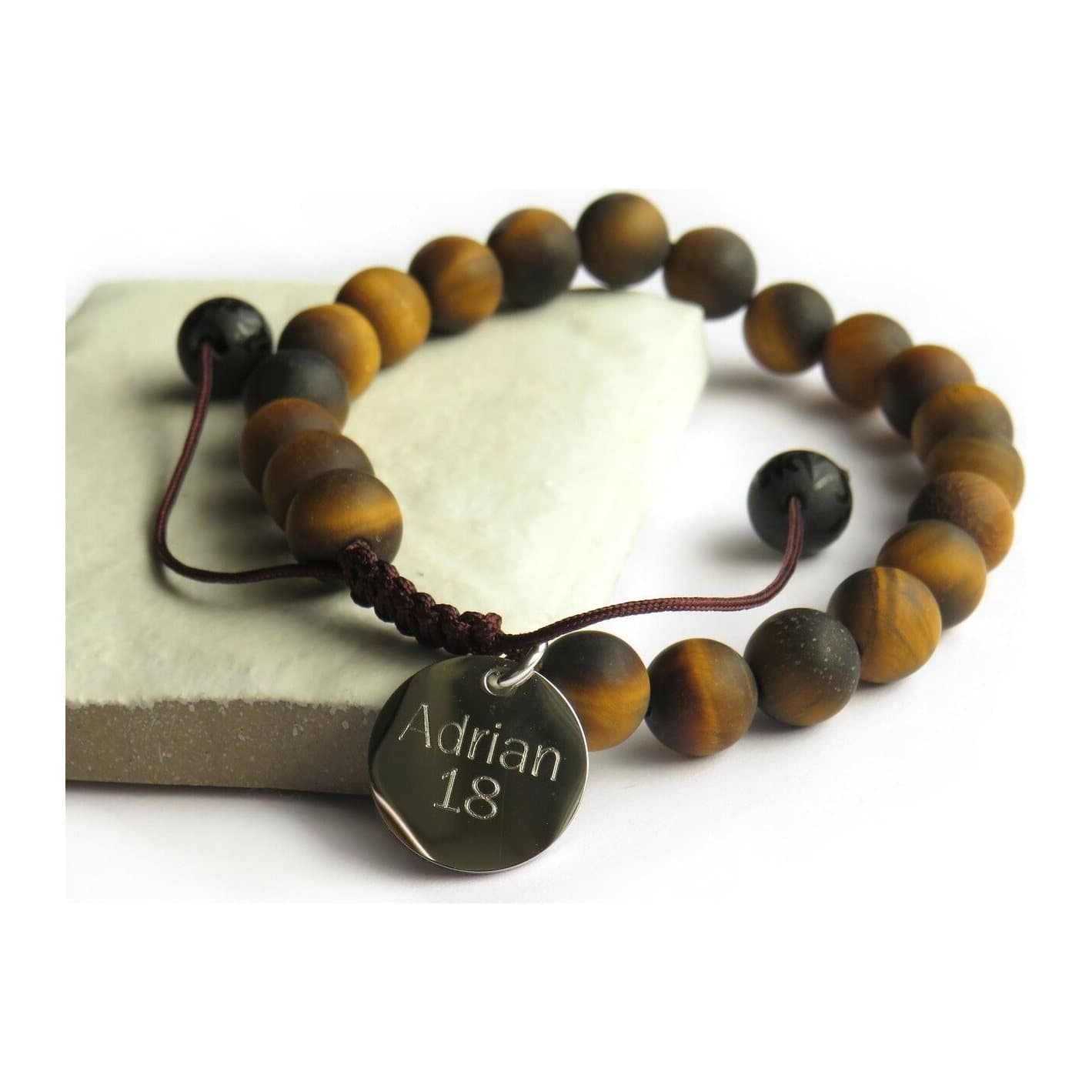 Men's tiger's eye bead bracelet with a round shiny metal charm