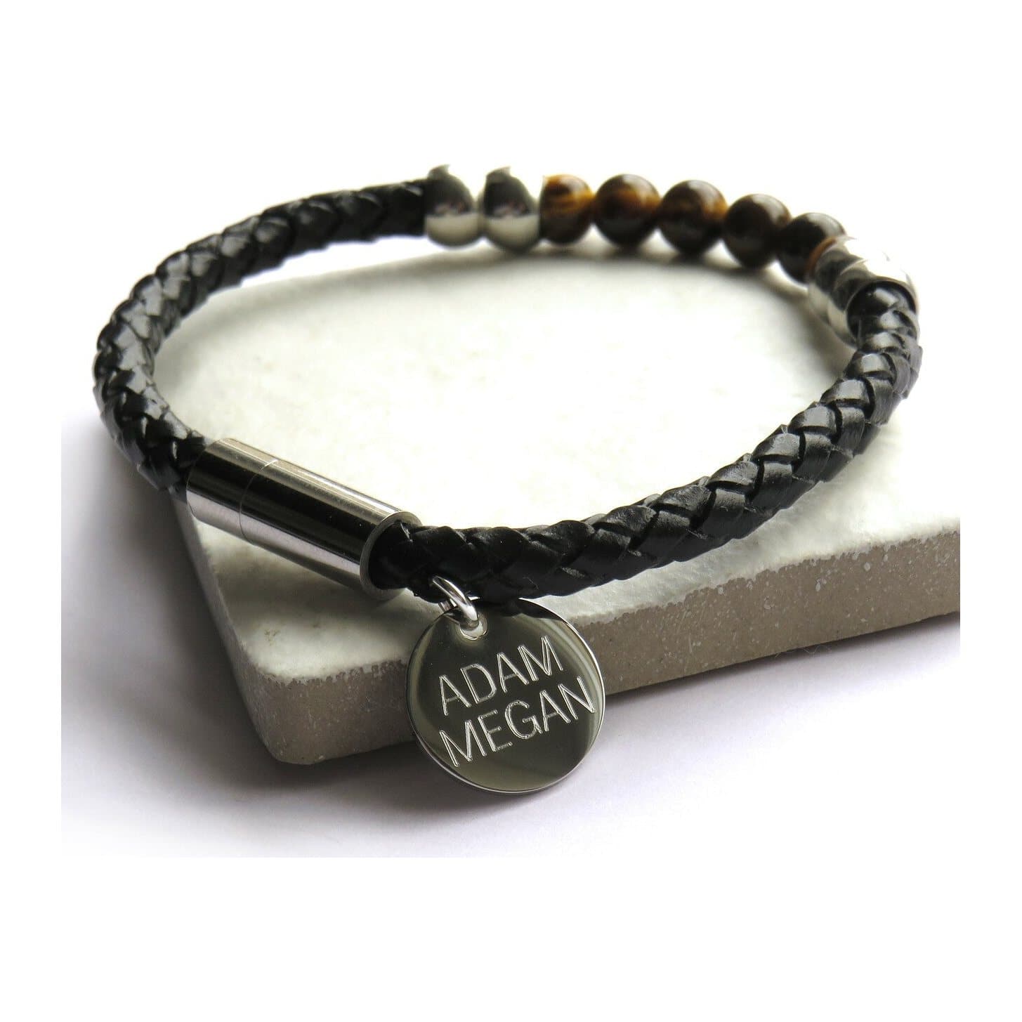 Men's braided faux leather bracelet with a round engraved stainless steel disc.