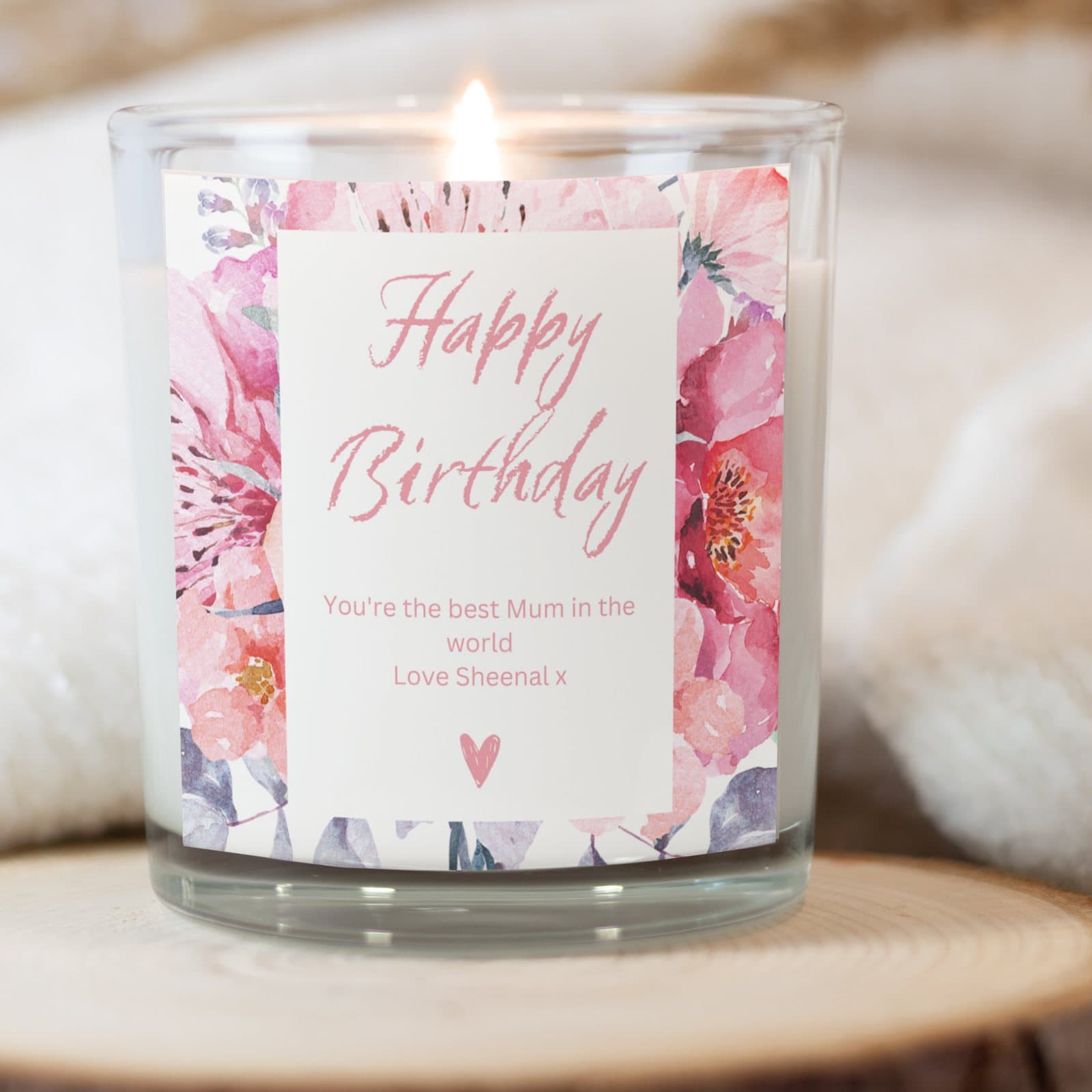 Pink birthday candle with a flower design, with red foiled chocolate hearts and matches