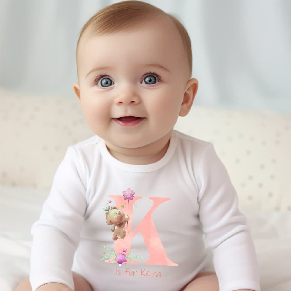 Pink baby grow, vest or bib with a teddy bear and initial design