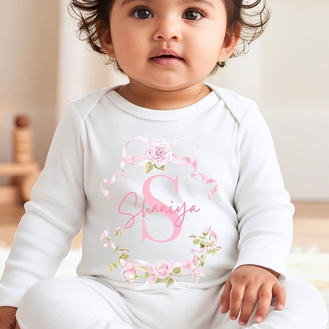Personalised pink roses baby outfit with a name, in a vest, baby grow or bib style.