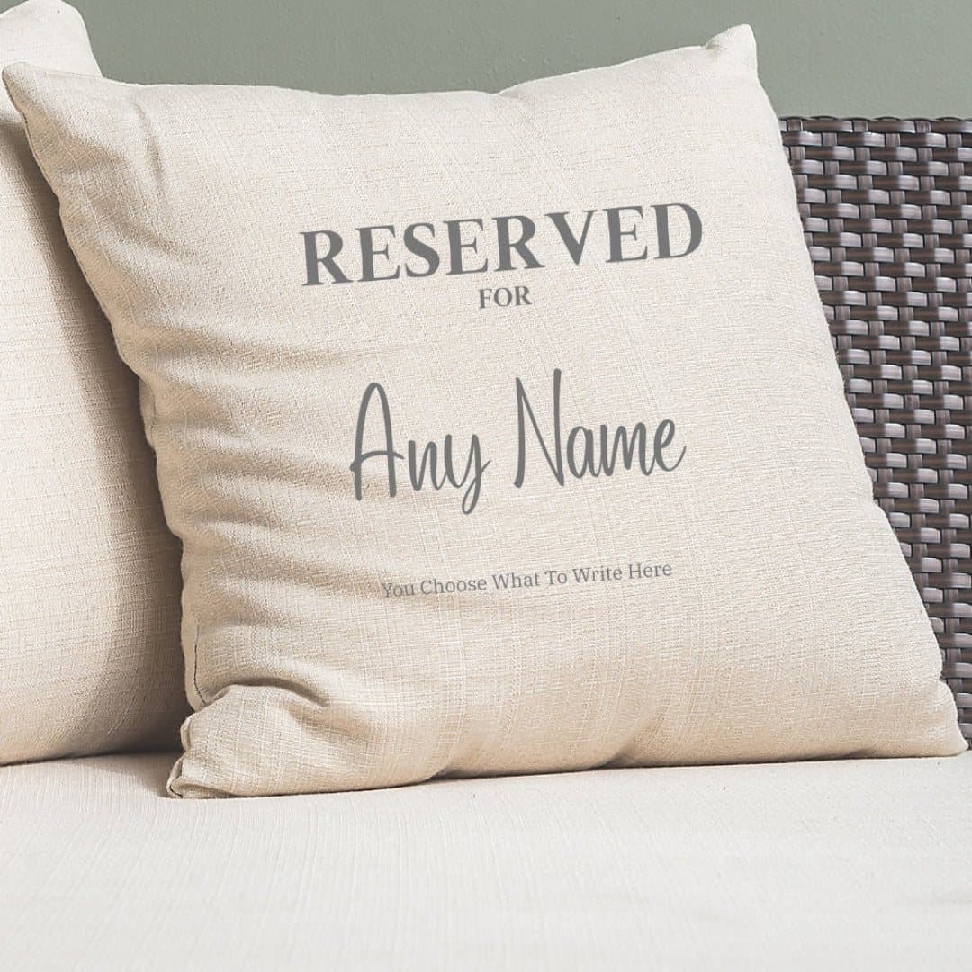 Cream square cushion printed with Reserved for and a personalised name