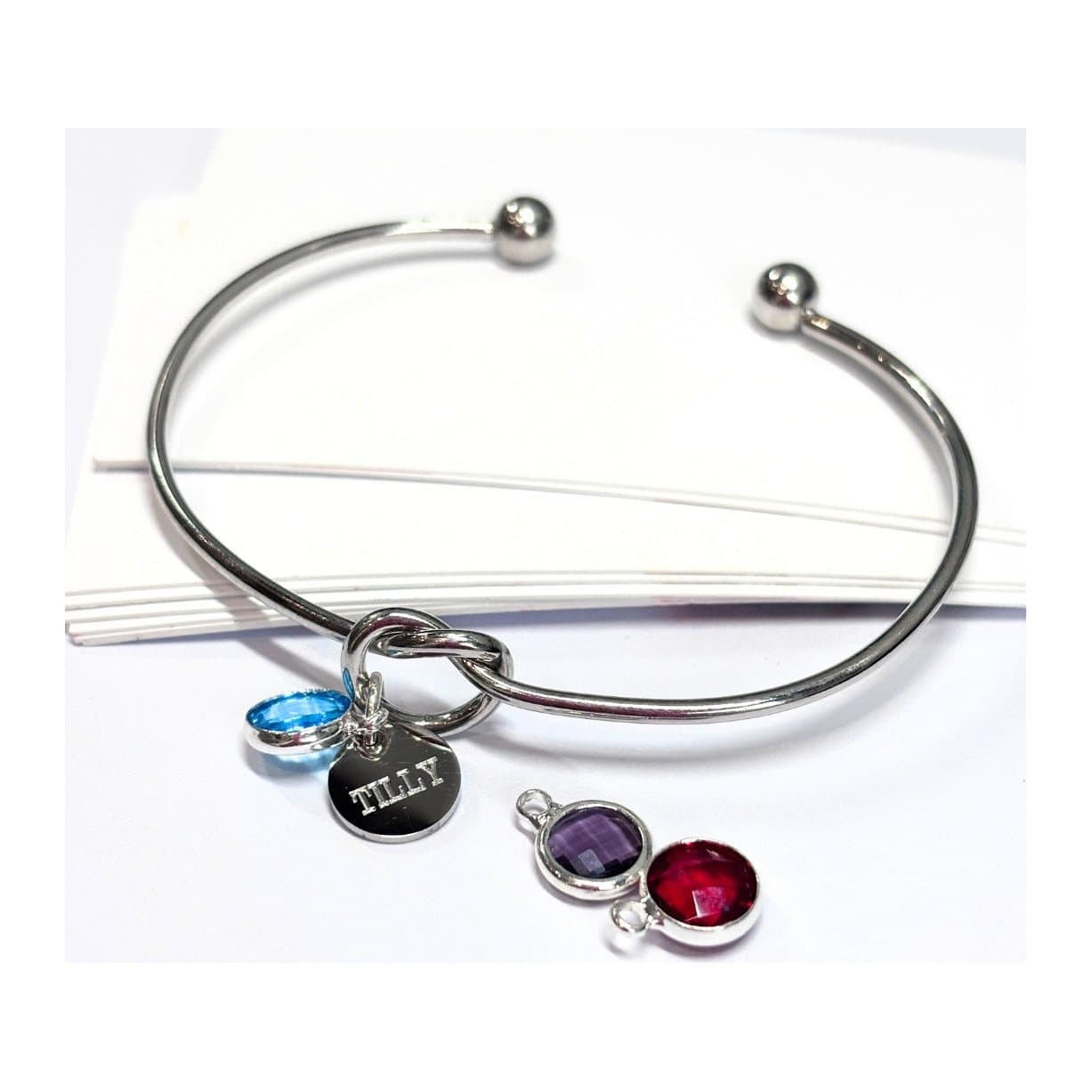 Personalised silver bangle with a birthstone charm and engraved disc