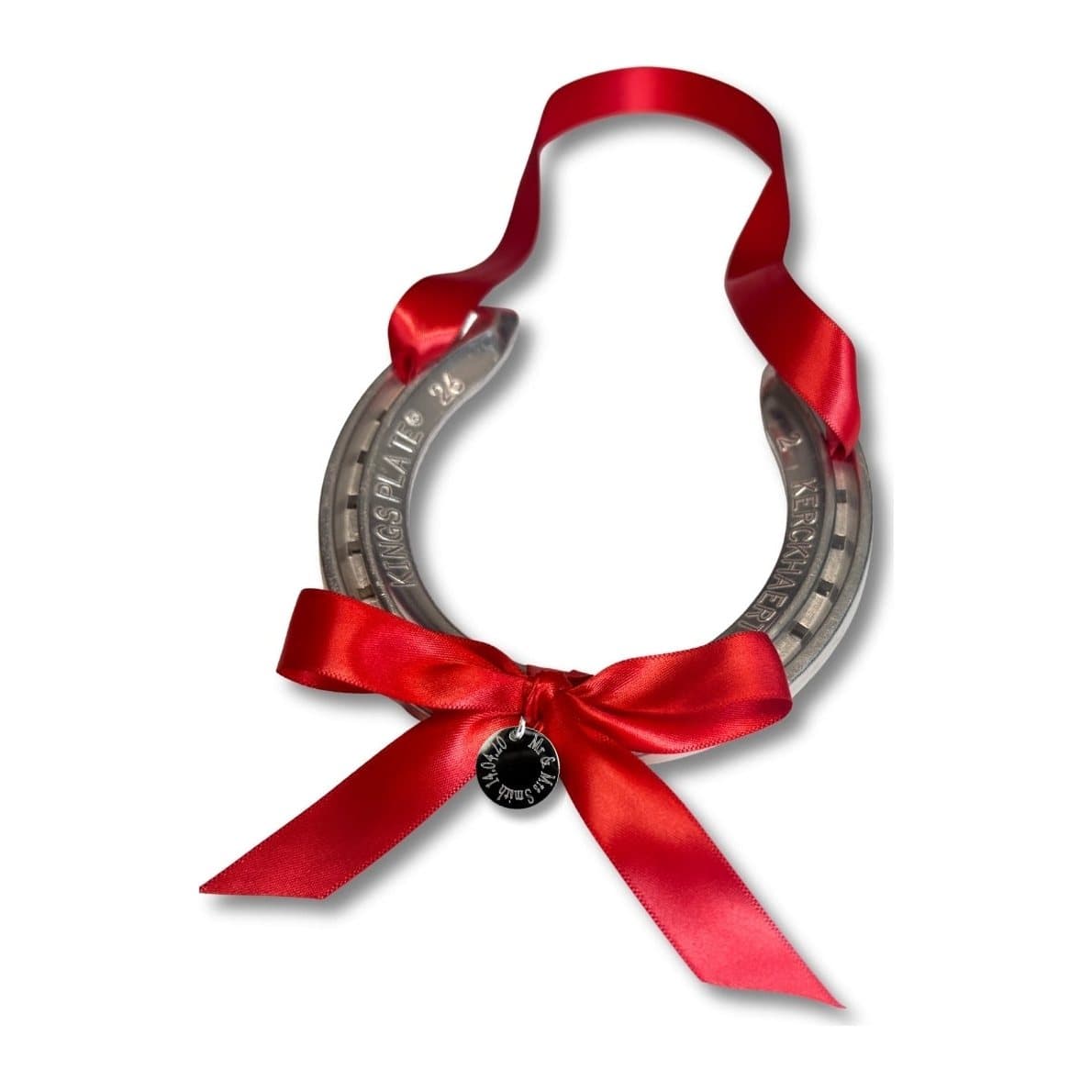 Silver horseshoe with a red ribbon and a round engraved disc