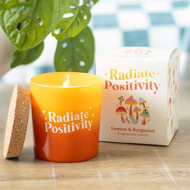 Lemon and bergamot candle in a yellow and orange glass pot with a cork lid