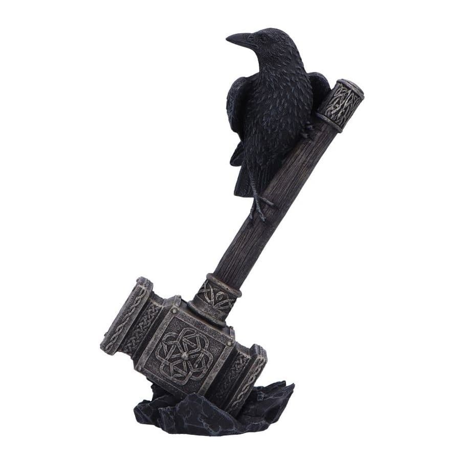 Black raven perched on Thor's hammer with a golden head amid black rocks