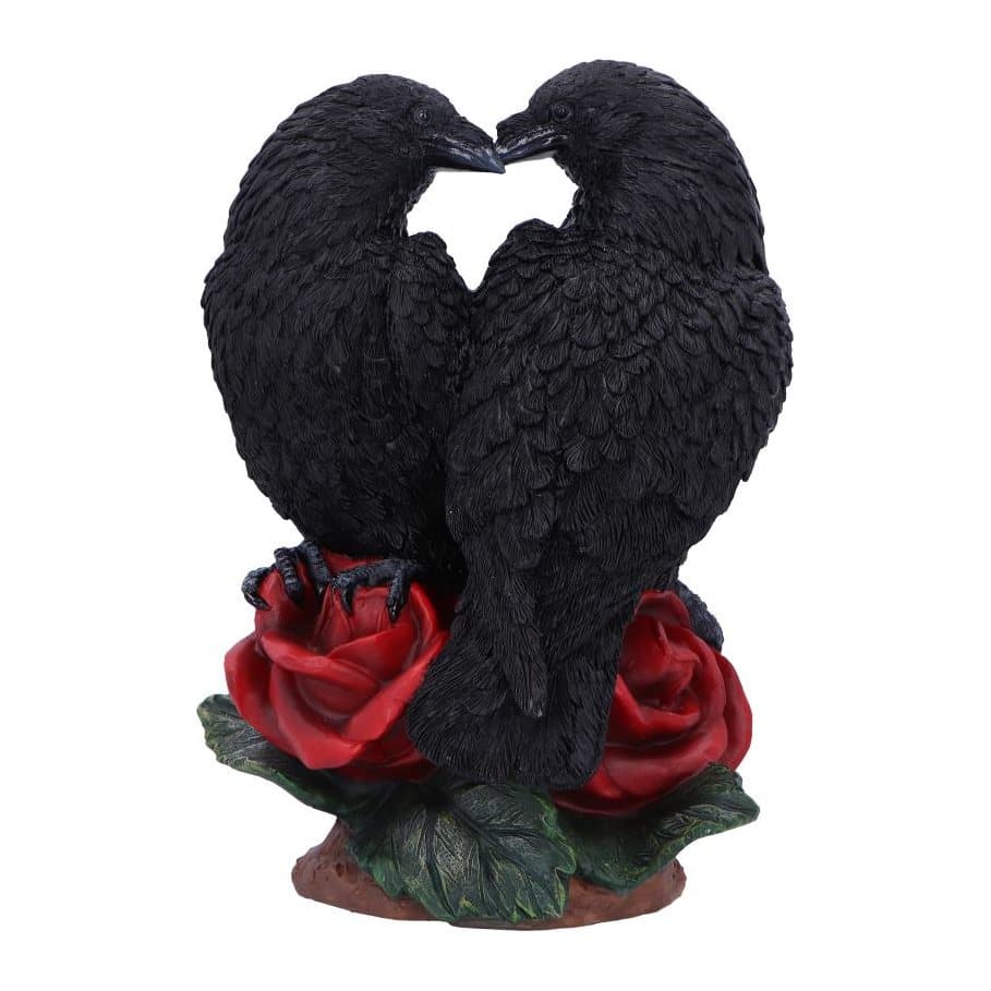 Two black resin ravens sitting together on deep red roses