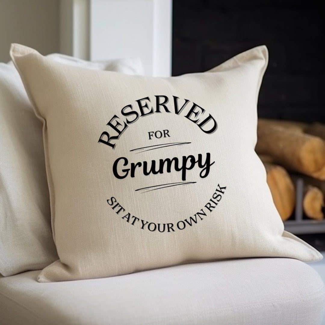 Cream linen-look cushion with the message Reserved For Grumpy, Sit at your own risk