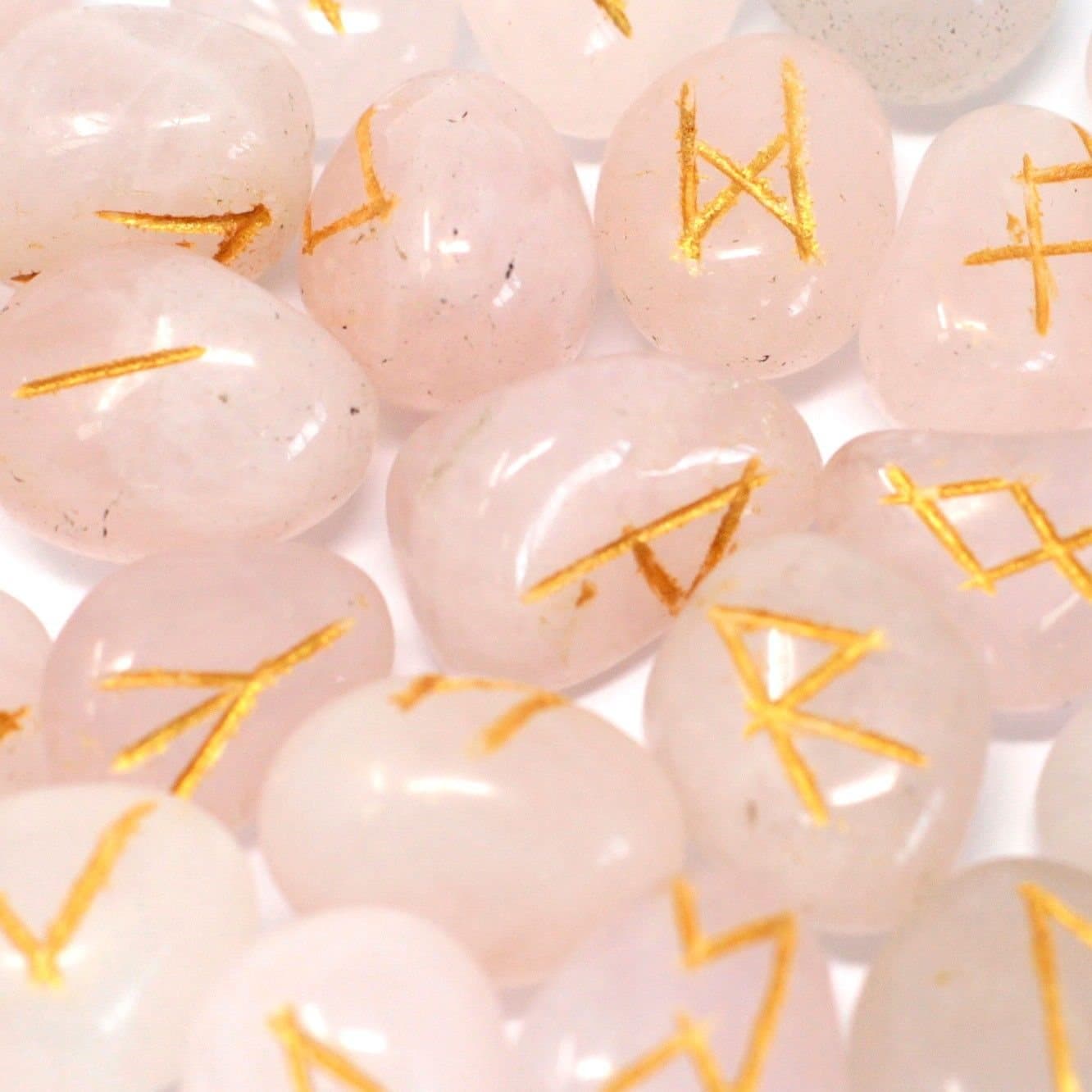 Rose quartz rune stones in a pouch, 24 with a rune symbol