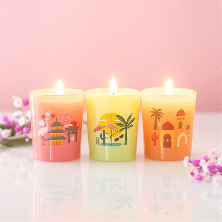 Three scented candles in a colour cardboard box with a window