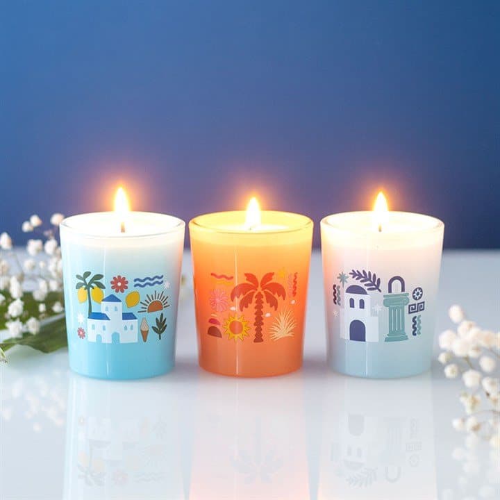 Three scented candles in a colour cardboard box with a window