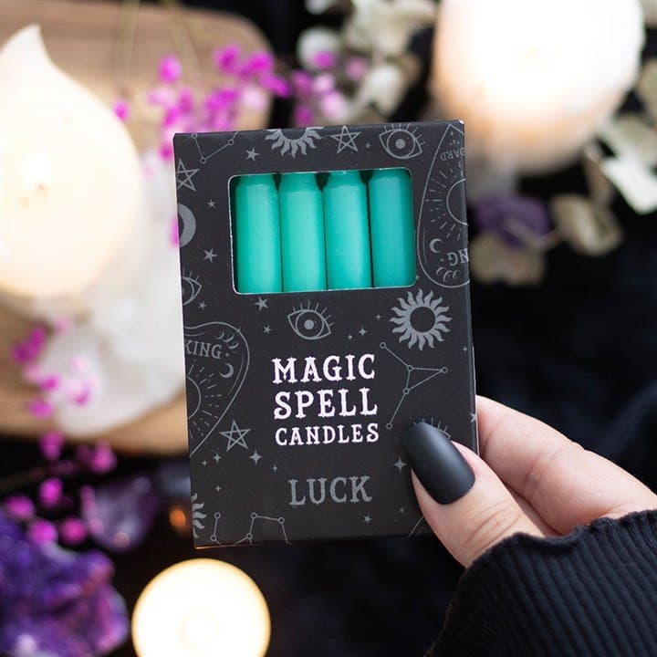 Set of 12 green luck spell candles in a window picture box